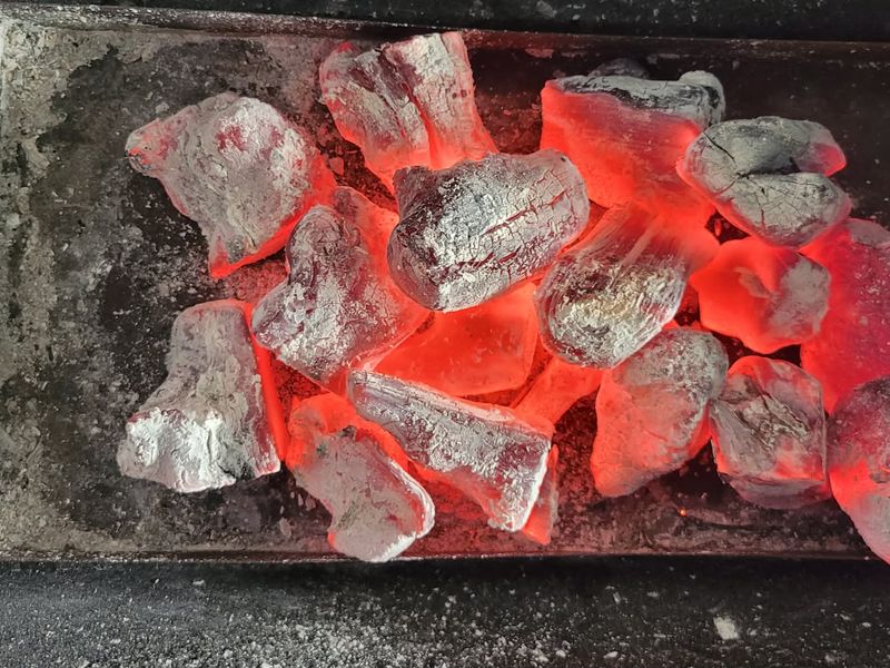 Coffee wood binchotan glowing at full heat with no visible flame