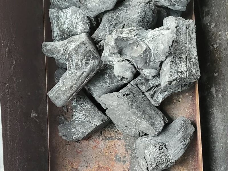 Coffee wood binchotan loaded into a tray before lighting